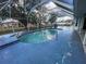 This inviting backyard pool has a screened-in enclosure and a serene atmosphere at 269 Rosemary St, Port Charlotte, FL 33954