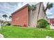 A view of the condominium building with well-maintained landscaping and several palm trees at 3100 Harbor Blvd # 116, Port Charlotte, FL 33952