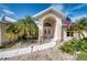 House entrance with double doors, arched entryway, and palm trees at 7369 Schefflera, Punta Gorda, FL 33955