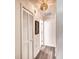 Light and airy hallway with updated flooring and a linen closet at 7369 Schefflera, Punta Gorda, FL 33955