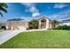 Tan house with metal roof, double door entry, and palm trees at 7369 Schefflera, Punta Gorda, FL 33955