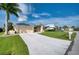 Large front yard with palm trees and a long driveway at 7369 Schefflera, Punta Gorda, FL 33955