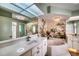 Elegant bathroom with a large bathtub, double vanity, and a tropical mural at 7369 Schefflera, Punta Gorda, FL 33955