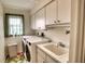Bright laundry room with washer, dryer, and ample storage at 7369 Schefflera, Punta Gorda, FL 33955