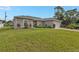 Single-story home with two-car garage and landscaped yard at 17440 Marcy Ave, Port Charlotte, FL 33948