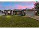 Single-story home with two-car garage and landscaped yard at 17440 Marcy Ave, Port Charlotte, FL 33948