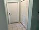 Small laundry area with storage and exterior access at 512 Chamber Nw St, Port Charlotte, FL 33948