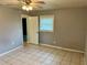 Gray bedroom with tile floors and a window at 512 Chamber Nw St, Port Charlotte, FL 33948