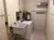 Functional laundry room with utility sink and shelving at 512 Chamber Nw St, Port Charlotte, FL 33948