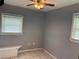 Bedroom with ceiling fan, tile floors, and window blinds at 512 Chamber Nw St, Port Charlotte, FL 33948