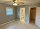 Bedroom with gray walls, tile floors and en-suite bathroom at 512 Chamber Nw St, Port Charlotte, FL 33948