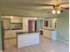 Kitchen features island, white cabinets, and tile flooring at 512 Chamber Nw St, Port Charlotte, FL 33948
