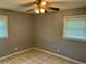 Simple bedroom with ceiling fan and tile floors at 512 Chamber Nw St, Port Charlotte, FL 33948