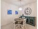 Bright dining area with round table, four chairs, and a teal buffet at 14131 Heritage Landing Blvd # 838, Punta Gorda, FL 33955