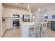 Modern kitchen with large island, white cabinets, and stainless steel appliances at 14131 Heritage Landing Blvd # 838, Punta Gorda, FL 33955