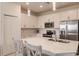 Modern kitchen with large island, white cabinets, and stainless steel appliances at 14131 Heritage Landing Blvd # 838, Punta Gorda, FL 33955