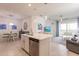 Open concept kitchen with island, stainless steel appliances, and views to living room at 14131 Heritage Landing Blvd # 838, Punta Gorda, FL 33955