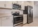 Modern kitchen featuring stainless steel appliances and white cabinetry at 14131 Heritage Landing Blvd # 838, Punta Gorda, FL 33955