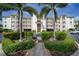 Three-story building with palm trees and parking at 1250 W Marion Ave # 222, Punta Gorda, FL 33950