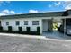 Front view of condo with carport and well manicured hedges at 7739 38Th N Pl, St Petersburg, FL 33709