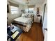 Bedroom with hardwood floors, ceiling fan and dresser at 7739 38Th N Pl, St Petersburg, FL 33709