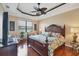 Spacious main bedroom features tray ceiling, large windows, and hardwood floors at 1751 Scarlett Ave, North Port, FL 34289