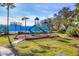 Playground with slide and climbing structure in community with blue fenced tennis courts at 1751 Scarlett Ave, North Port, FL 34289