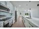 Modern kitchen with white shaker cabinets, quartz countertops, and stainless steel appliances at 16 Tee View Rd, Rotonda West, FL 33947