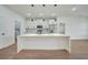 Modern kitchen with white cabinets, quartz countertops, and stainless steel appliances at 16 Tee View Rd, Rotonda West, FL 33947
