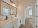Modern bathroom with double vanity and a large mirror at 16 Tee View Rd, Rotonda West, FL 33947