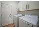 Laundry room with washer, dryer, cabinets, and extra storage at 16 Tee View Rd, Rotonda West, FL 33947