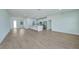 Open living room and kitchen area with light hardwood flooring at 16 Tee View Rd, Rotonda West, FL 33947