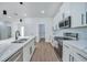 Bright kitchen featuring white cabinets, stainless steel appliances, and a large island at 16 Tee View Rd, Rotonda West, FL 33947