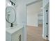 Simple bathroom with a single sink and view of a hallway at 16 Tee View Rd, Rotonda West, FL 33947