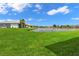Landscaped backyard with a peaceful lake view at 24703 Buckingham Way, Punta Gorda, FL 33980