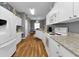 Bright kitchen with white cabinets, granite countertops, and stainless steel appliances at 24703 Buckingham Way, Punta Gorda, FL 33980