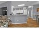 Modern kitchen with white cabinets and a breakfast bar at 24703 Buckingham Way, Punta Gorda, FL 33980