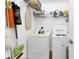 Laundry room with washer, dryer, and ample shelving for storage at 24703 Buckingham Way, Punta Gorda, FL 33980