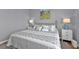 Bedroom with a queen-size bed and a neutral color scheme at 24703 Buckingham Way, Punta Gorda, FL 33980