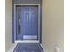 Inviting front door entrance with a blue door and decorative mat at 24703 Buckingham Way, Punta Gorda, FL 33980