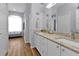 Double vanity bathroom with granite countertops and a walk-in shower at 24703 Buckingham Way, Punta Gorda, FL 33980
