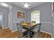 Cozy dining area with a wood table and four chairs, located near the kitchen at 24703 Buckingham Way, Punta Gorda, FL 33980