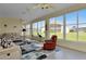 Bright sunroom with comfortable seating and backyard view at 24703 Buckingham Way, Punta Gorda, FL 33980