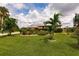 Beautiful Florida home with lush landscaping and palm trees at 2216 Pellam Blvd, Port Charlotte, FL 33948