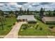 Bird's-eye view of the home, showcasing landscaping and driveway at 2216 Pellam Blvd, Port Charlotte, FL 33948