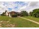 Landscaped backyard with a view of the canal and lush greenery at 2216 Pellam Blvd, Port Charlotte, FL 33948