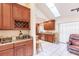 Kitchen features wood cabinets, granite countertops, and a wine rack at 2216 Pellam Blvd, Port Charlotte, FL 33948