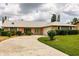Single-story house with a unique facade and landscaped yard at 2216 Pellam Blvd, Port Charlotte, FL 33948