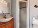 Clean and simple bathroom featuring a shower and wooden vanity at 2216 Pellam Blvd, Port Charlotte, FL 33948