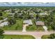 Aerial view of a canal-front house with a large yard at 2216 Pellam Blvd, Port Charlotte, FL 33948